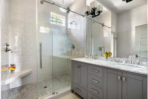 a bathroom with a glass shower and a sink at Perfect Location - King Street Condo in Charleston