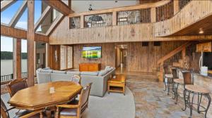 a living room with a couch and a table at The Royal Chateau-5BED6BATHPoolHottub-20PP in Osage Beach
