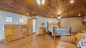 a bedroom with a bed and a wooden ceiling at The Royal Chateau-5BED6BATHPoolHottub-20PP in Osage Beach +81 photos