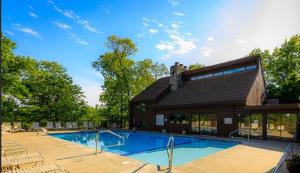 a swimming pool with chairs and a building at The Royal Chateau-5BED6BATHPoolHottub-20PP in Osage Beach