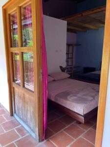 a room with a bed and an open door at Suelo Vivo Eco Hotel in Bochalema