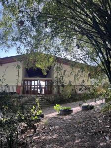 a house with a porch and a wooden fence at Suelo Vivo Eco Hotel in Bochalema