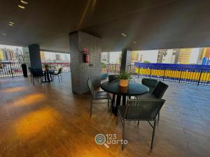 a dining room with tables and chairs in a building at Solaz Smart Living by 123Quarto in Tambaú +40 photos