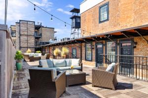 a patio with couches and chairs on a balcony at King Street Condo - Endless Outdoor Space in Charleston