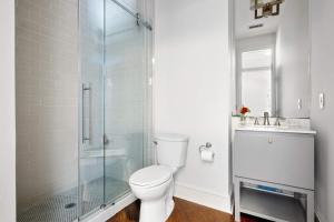 a bathroom with a toilet and a shower and a sink at King Street Condo - Endless Outdoor Space in Charleston +10 photos
