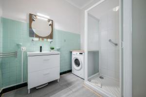 a bathroom with a washing machine and a mirror at Le COQ Livieri - AC- WiFi - Seafront - town centre in Menton +48 photos