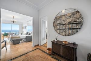 a living room with a large mirror on the wall at Le COQ Livieri - AC- WiFi - Seafront - town centre in Menton