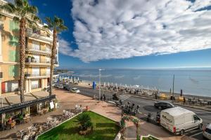 a view of a street with a building and the ocean at Le COQ Livieri - AC- WiFi - Seafront - town centre in Menton
