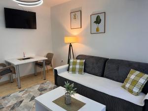a living room with a couch and a table at Central DELUXE Apartment in Prilep