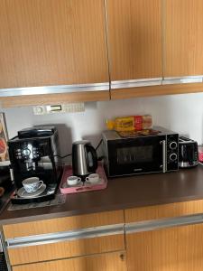 a kitchen counter with a microwave and a coffee maker at MemmingenBuxheimKartause in Buxheim