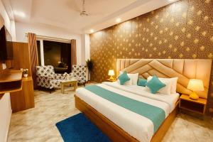 a bedroom with a large bed in a room at Hotel The Meridian, Haridwar in Haridwār