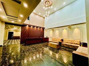 a large room with a pew and a synagogue at Hotel The Meridian, Haridwar in Haridwār
