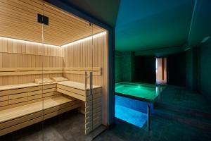 a sauna with a tub in the middle of a room at Casa Serras Andorra in Andorra la Vella