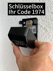 een hand die een mobiele telefoon in een stopcontact houdt bij MemmingenBuxheimKartause in Buxheim