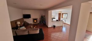 a living room with a couch and a christmas tree at Quinta da Canda in Cerva