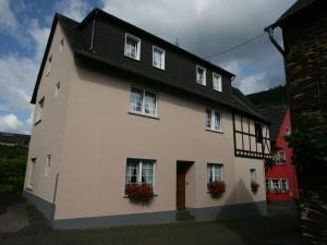 a large white building with flowers in the windows at Apartment FEWO Veilchen by Interhome in Ernst