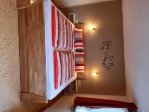 a room with a bunk bed with red and white blankets at Apartment FEWO Veilchen by Interhome in Ernst