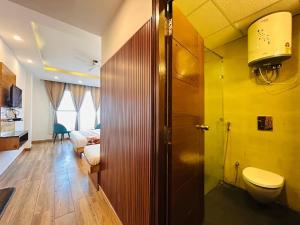a bathroom with a toilet and a sink in a room at The Pine Mountain View A Rooftop Restaurant & Luxury Balcony Rooms! in Mussoorie +64 photos