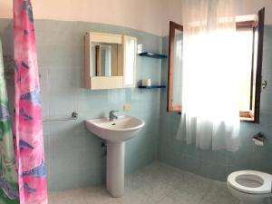 a bathroom with a sink and a toilet at Apartment Jasmin by Interhome in Fauglia +14 photos