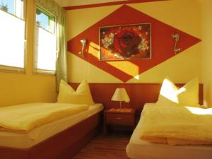 a room with two beds and a painting on the wall at Holiday Home mit Pool by Interhome in Radewege