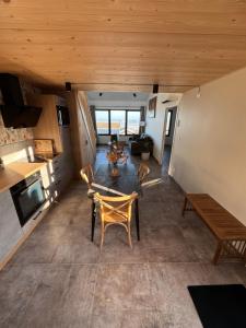 a view of a living room with a table and chairs at Lodges des Pontons - Cap Est - vue mer in Saint-Côme-de-Fresné +19 photos