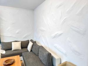 a living room with a couch and a white wall at Apartment Daun by Interhome in Daun