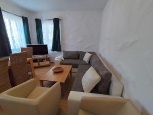 a living room with a couch and a table at Apartment Daun by Interhome in Daun
