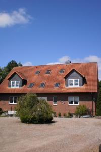 a large house with a red roof with windows at Apartment Schule 5 by Interhome in Windeby