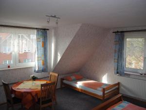 a bedroom with a bed and a table and window at Apartment Schule 5 by Interhome in Windeby