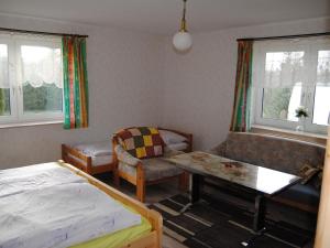 a bedroom with a bed and a couch and a table at Apartment Schule 4 by Interhome in Windeby
