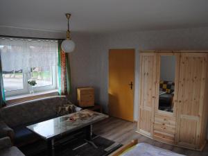 a living room with a couch and a table at Apartment Schule 4 by Interhome in Windeby