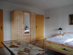 a bedroom with a bed and a glass table at Apartment Schule 4 by Interhome in Windeby +8 photos