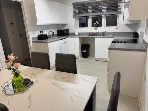 a kitchen with a table with a vase of flowers on it at Kennard Haven in Weldon