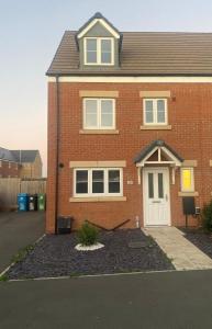 a red brick house with a white door at Kennard Haven in Weldon