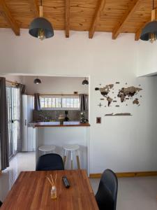 een keuken en eetkamer met een houten tafel en stoelen bij El Cerrito in Las Heras