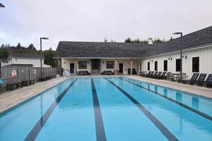 a large swimming pool with blue water in front of a building at wave watchers in Pacific Beach