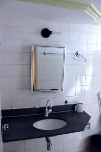 a bathroom with a sink and a mirror at Apart Service Araras - VPC in Caldas Novas +37 photos