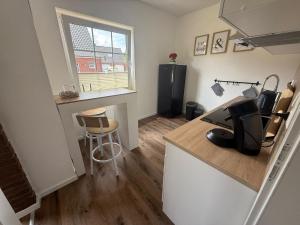 a kitchen with a counter with a computer on it at Huus Christine in Holtgast