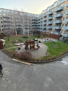 a park with a playground in the middle of a building at 120 m2 newly renovated apartment in Copenhagen
