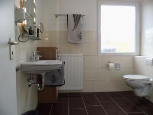 a bathroom with a sink and a toilet at Apartment Fewo Edison by Interhome in Holzdorf