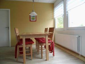 a dining room with a table and chairs and a window at Apartment Fewo Edison by Interhome in Holzdorf