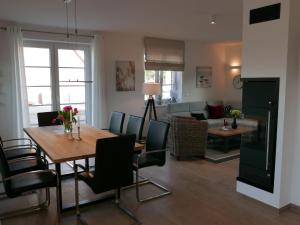 a dining room and living room with a table and chairs at Holiday Home Knut by Interhome in Mellnitz