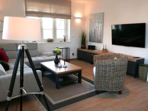 a living room with a couch and a table at Holiday Home Knut by Interhome in Mellnitz