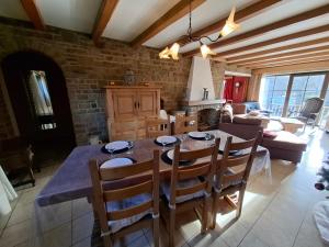 a kitchen and living room with a table and chairs at L'Echappée Belle in Beauraing