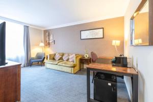 a living room with a couch and a table at Winchester Wessex Hotel by Sunday in Winchester