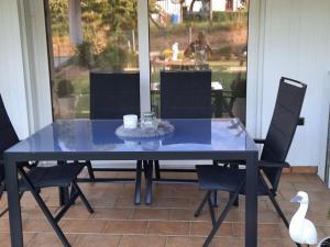 a blue table and chairs on a patio with a swan at Apartment Panoramablick Rhön by Interhome in Sandberg