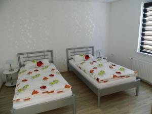two beds in a room with white walls at Apartment Fewo Berliner by Interhome in Holzdorf