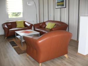 a living room with two leather chairs and a table at Apartment Fewo Berliner by Interhome in Holzdorf