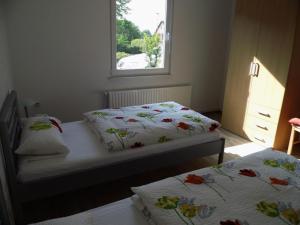 two beds in a bedroom with a window at Apartment Fewo Berliner by Interhome in Holzdorf