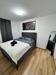 a bedroom with a bed with a hat on it at Aurora Noir Retreat in Banja Luka +23 photos